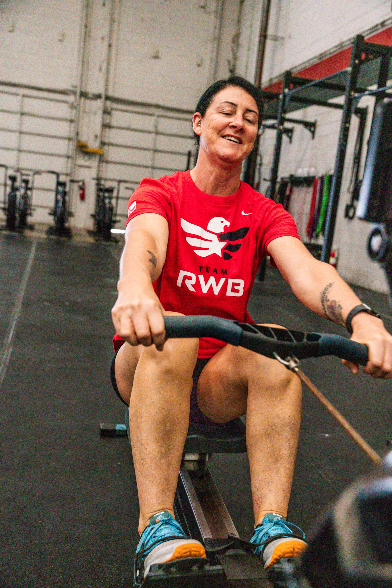 Woman rowing in Team RWB Women's Nike Dri-FIT T-Shirt – gym training
