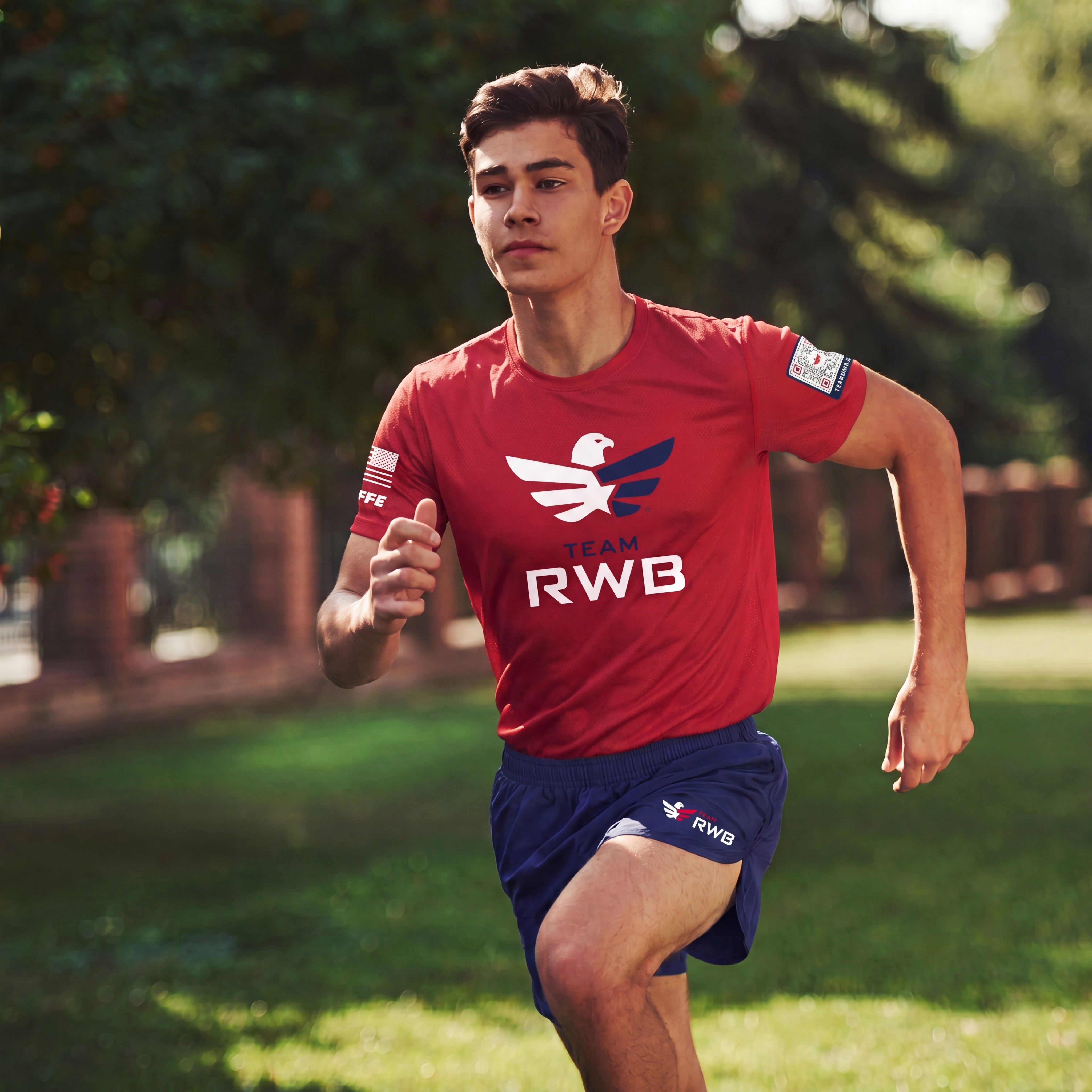 Person running outdoors wearing a red sports jersey with 'RWB' branding.
