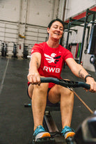 Woman rowing in Team RWB Women's Nike Dri-FIT T-Shirt – gym training