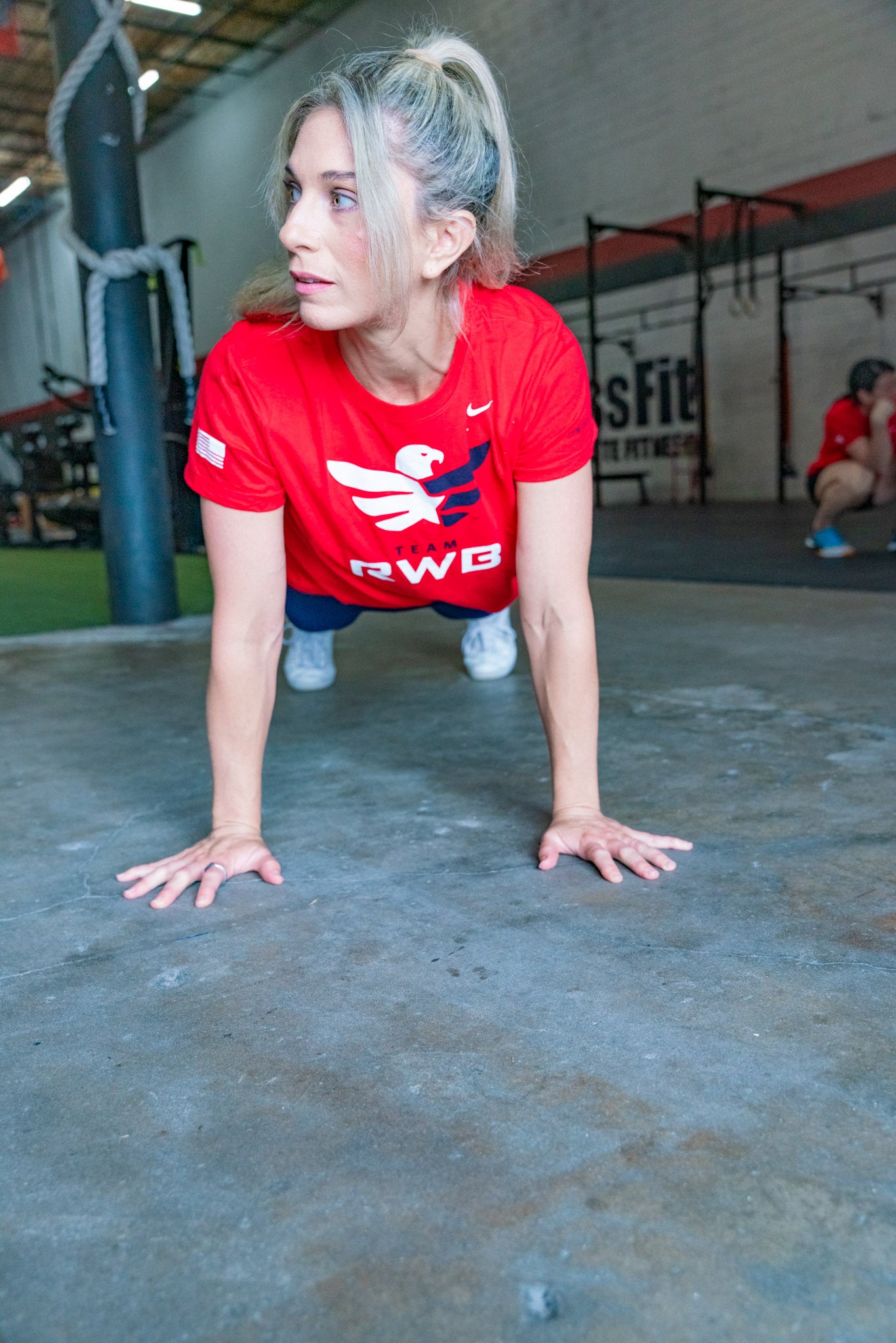 Woman doing push-ups in Team RWB Women's Nike Dri-FIT T-Shirt