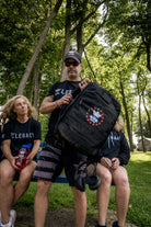 Team RWB Legacy GORUCK GR1 Rucksack lifestyle shot – full pack view showing black 1000D CORDURA construction and anniversary branding
