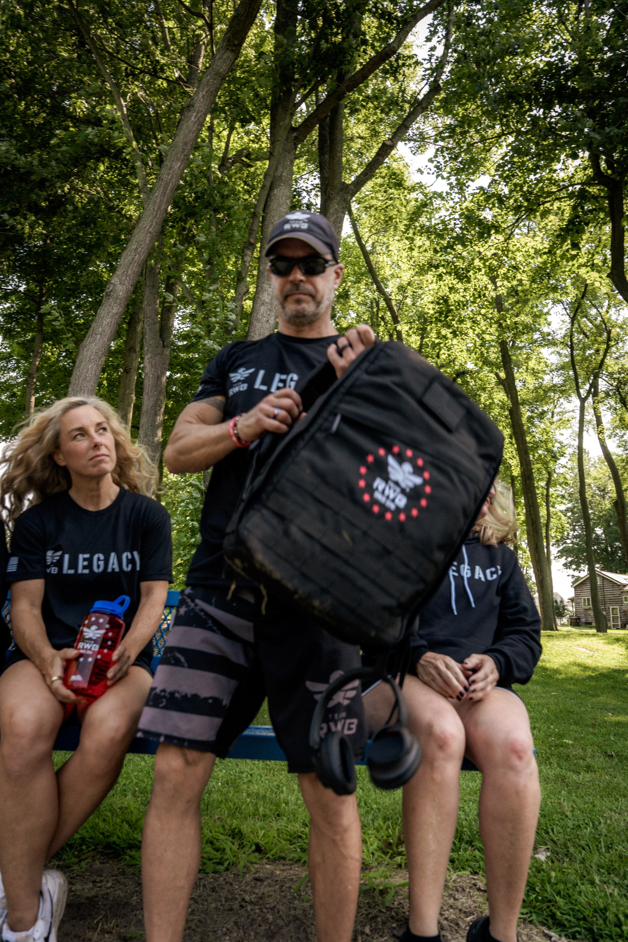 Team RWB Legacy GORUCK GR1 Rucksack lifestyle shot – full pack view showing black 1000D CORDURA construction and anniversary branding